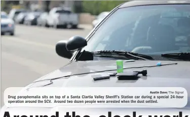  ?? Austin Dave/The Signal ?? Drug parapherna­lia sits on top of a Santa Clartia Valley Sheriff’s Station car during a special 24-hour operation around the SCV. Around two dozen people were arrested when the dust settled.