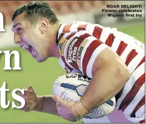  ?? Picture: MAGI HAROUN ?? ROAR DELIGHT: Flower celebrates
Wigan’s fi rst try