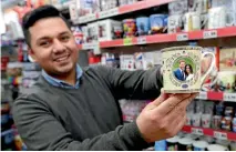  ??  ?? Salman Qadir, manager of the King and Queen gift shop in Windsor, is among those making more light-hearted preparatio­ns for the big day.