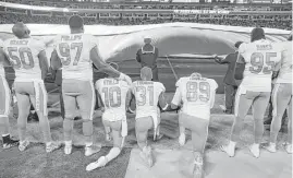  ?? Bob Leverone / Associated Press ?? Some Miami Dolphins players kneel during the national anthem this month.