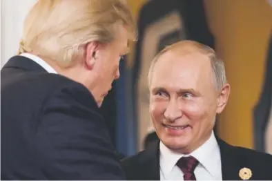  ?? Mikhail Klimentyev, Afp/getty Images file ?? President Donald Trump chats with Russia’s President Vladimir Putin during the Asia-pacific Economic Cooperatio­n leaders’ summit in Danang, Vietnam, on Nov. 11.