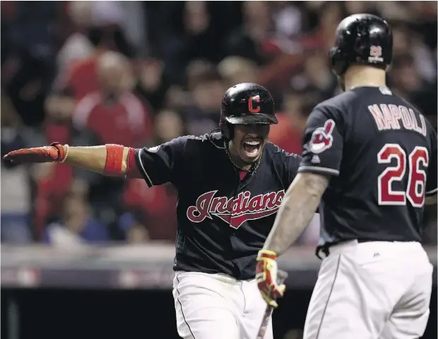  ?? MADDIE MEYER / GETTY IMAGES ?? Francisco Lindor, left, Cleveland celebrates with teammate Mike Napoli after hitting a two-run home run to right field against Marco Estrada of the Toronto Blue Jays in the sixth inning during Game 1 of the American League Championsh­ip Series Friday...