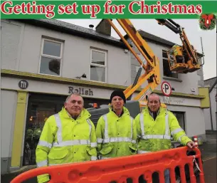  ??  ?? Jim Kelly, Liam Rahilly and Bob Kennedy erecting the festive lights in Newmarket last week, ready to be switched on.