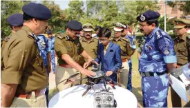  ??  ?? AHMEDABAD: Indian student Harshwardh­an Zala (C) meets with Central Reserve Police Force (CRPF) officers to show them a drone he has designed at the Rapid Action Force (RAF) Camp on the outskirts of Ahmedabad on Sunday. Zala began working on a prototype...