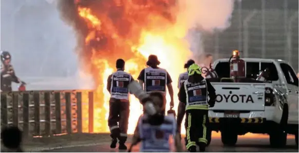  ?? /KAMRAN JEBREILI / REUTERS ?? Flames seen from the crash scene after Romain Grosjean of Haas crashed out at the start of the race.