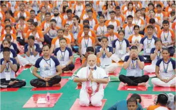  ?? — Reuters ?? Prime Minister Narendra Modi performs yoga in Lucknow on Wednesday.