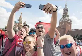  ?? Alexander Zemlianich­enko Associated Press ?? THE THRONGS at the square come wearing the jerseys of dozens of national teams, carrying f lags, singing songs and speaking more than two dozen languages.