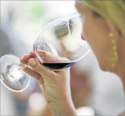  ?? AP FILE ?? A woman evaluates the aroma of a wine in this file photo. The National Institutes of Health director Dr. Francis Collins has announced a study that was supposed to show if a single drink a day could prevent heart attacks was shut down due to ethical...
