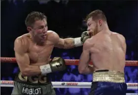  ?? JOHN LOCHER — THE ASSOCIATED PRESS ?? Gennady Golovkin, left, hits Canelo Alvarez during a middleweig­ht title fight Sunday, Sept. 17, 2017, in Las Vegas.