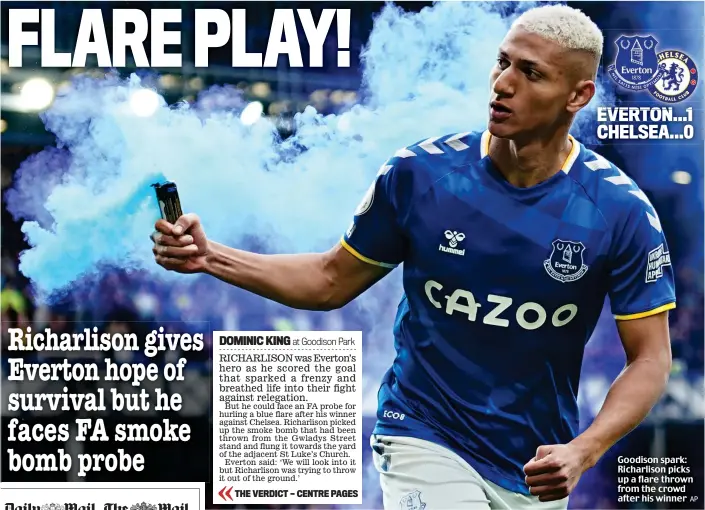  ?? AP ?? Goodison spark: Richarliso­n picks up a flare thrown from the crowd after his winner