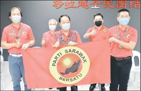  ??  ?? (From left) Baru, Nicholas, Wong, PSB secretary-general George Lo, and See pose with the PSB flag. — Photo by Muhammad Rais Sanusi