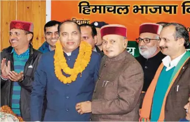  ??  ?? Himachal Pradesh CM Jai Ram Thakur being congratula­ted by former CM P. K. Dhumal on getting the top post.