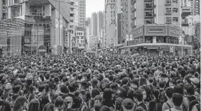  ?? Photos by Anthony Kwan, Getty Images ?? Pro-autonomy demonstrat­ions spilled into some of Hong Kong’s most popular tourist areas days before Monday’s planned general strike — backed by thousands of businesses, airline workers’ unions, trade unions and others.