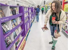  ?? SARAH ESPEDIDO/ORLANDO SENTINEL ?? “These DVDs are what brings me out,” said Heather Peeples. She perused the bargains at Walmart on Black Friday 2019.