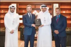  ?? ?? Prof Dr Recep Senturk, Dean of the College of Islamic Studies at Hamad Bin Khalifa University, handed a commemorat­ive shield to QIIB CEO Dr Abdulbasit Ahmed Al Shaibei