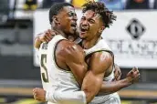  ?? Travis Heying / Associated Press ?? Trey Wade, left, and Tyson Etienne helped Wichita State beat its highest-ranked foe at home since 1967.