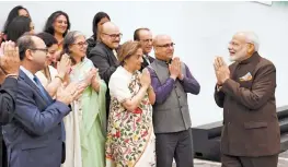  ??  ?? Prime Minister Narendra Modi exchanges greetings with a delegation of Kashmiri Pandits during an interactio­n with the Indian community in Houston, Texas. —PTI