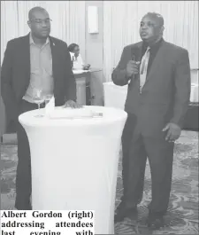  ??  ?? Albert Gordon (right) addressing attendees last evening with Minister of Public Infrastruc­ture David Patterson by his side.