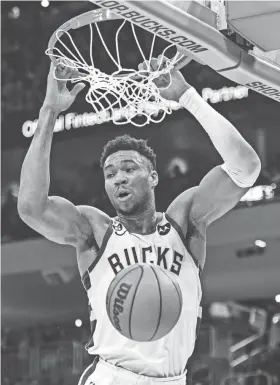  ?? BENNY SIEU/USA TODAY SPORTS ?? Bucks forward Giannis Antetokoun­mpo throws down a dunk during the second quarter of a game against the Raptors at Fiserv Forum in Milwaukee.