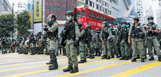  ?? Picture: Reuters. ?? Riot police stand guard during a march against Beijing’s plans to impose national security legislatio­n in Hong Kong yesterday. Also see P10