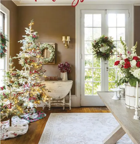  ?? ?? If you have the space, place a few Christmas trees in the dining room for a festive view while you dine with family. Leslie suggests removing dining chairs for any holiday gatherings to allow for walking space.