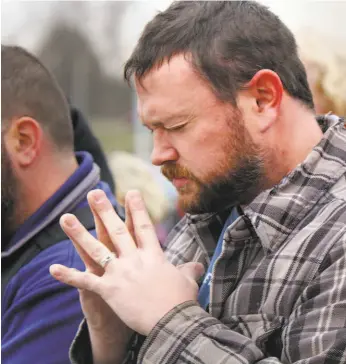  ?? William D. Lewis / Youngstown (Ohio) Vindicator ?? Matthew, a General Motors employee who has worked 17 years at the auto plant in Lordstown, Ohio, prays after GM announced layoffs at the factory last month.