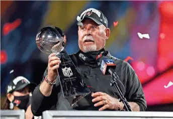  ?? AP ?? Tampa Bay coach Bruce Arians holds the Vince Lombardi trophy following Super Bowl 55. Arians became the oldest coach at age 68 to win the Super Bowl.