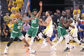  ?? Strazzante/san Francisco Chronicle via AP ?? Golden State Warriors’ Stephen Curry passes the ball past Boston Celtics’ Al Horford (42) and Marcus Smart Thursday during the fourth quarter of Game 1 of basketball’s NBA Finals in San Francisco.