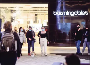  ?? Ned Gerard / Hearst Connecticu­t Media ?? Black Friday shoppers outside Bloomingda­le’s at The SoNo Collection in Norwalk. On the eve of December, Bloomingda­le’s and parent Macy’s were still filling jobs for the 2021 holiday season, offering pay for seasonal workers as high as $19.50 an hour depending on experience.