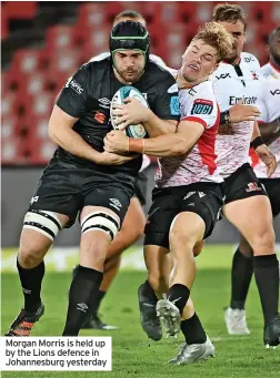  ?? ?? Morgan Morris is held up by the Lions defence in Johannesbu­rg yesterday