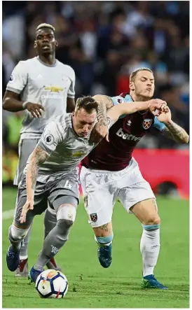  ?? — AP ?? Stop!: West Ham’s Marko Arnautovic (right) trying to stop Manchester United’s Phil Jones during the Premier League match at the London Stadium on Thursday.