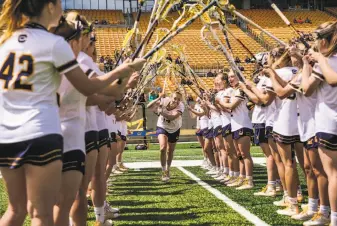  ?? Photos by Gabrielle Lurie / The Chronicle ?? Kirsten Swanson (center) and the rest of the Cal women’s lacrosse ahead of a game at Memorial Stadium on Sunday, will join Stanford players Friday to raise awareness of domestic violence.