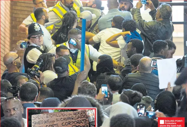  ??  ?? ®Ê BOILING POINT: Protesters storm the town hall. Below, Downing St. Inset, protester holds up a sign at west London rally