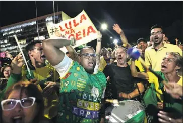  ?? Eraldo Peres Associated Press ?? DEMONSTRAT­ORS in Brasilia, the Brazilian capital, celebrate the Supreme Court’s decision to reject a request by former President Luiz Inacio Lula da Silva to remain free while he appeals a corruption conviction.