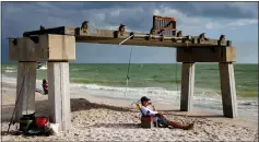  ?? SCOTT MCINTYRE — THE NEW YORK TIMES ?? The remains of a pier on Fort Myers Beach, Fla., last month. La Niña, the climate pattern that helped fuel the extremely active hurricane seasons and drought in the southwest over the past 21⁄2years, has ended, the National Oceanic and Atmospheri­c Administra­tion said Thursday.