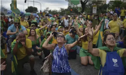  ?? Photograph: Anadolu Agency/Getty Images ?? Supporters of outgoing Jair Bolsonaro gather in Rio de Janeiro on Tuesday. Truck drivers have threatened a new protest in support of the defeated president.