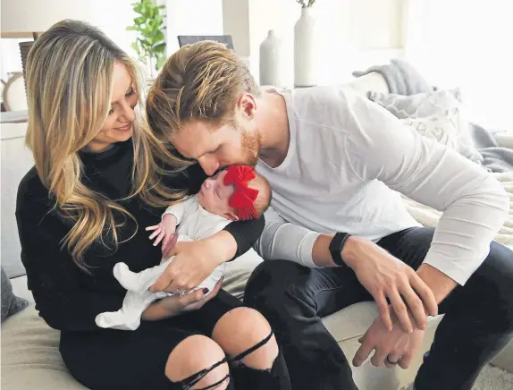  ?? Andy Cross, The Denver Post ?? Avalanche captain Gabe Landeskog and his wife, Melissa, spend time with their 6-week-old daughter, Linnea at their home last week.