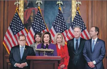  ?? Shawn Thew EPA/Shuttersto­ck ?? HOUSE SPEAKER Nancy Pelosi and Democratic leaders discuss the articles of impeachmen­t against President Trump. “The president’s continuing abuse of power has left us no choice,” one of the lawmakers said.