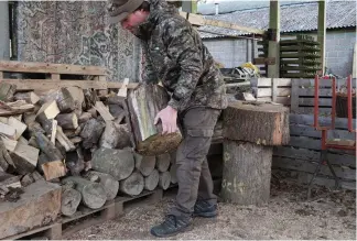  ??  ?? Mat moves a chopping block to create a seat so he can ambush rabbits from the handy woodshed