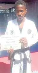  ?? ?? Tavere Webb holds the Under-15 title for the Jamaica Combined Martial Arts Team