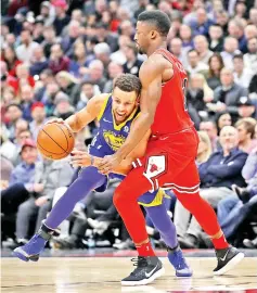  ?? - AFP photo ?? Stephen Curry #30 of the Golden State Warriors tries to move against David Nwaba #11 of the Chicago Bulls at the United Center on January 17, 2018 in Chicago, Illinois. The Warriors defeated the Bulls 119-112.