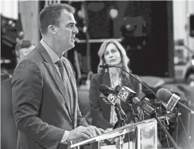 ?? CHRIS LANDSBERGE­R/THE OKLAHOMAN ?? Employment Security Commission Executive Director Shelley Zumwalt looks on as Gov. Kevin Stitt speaks during a May news conference to announce at $1,200 return-to-work incentive for unemployed Oklahomans.