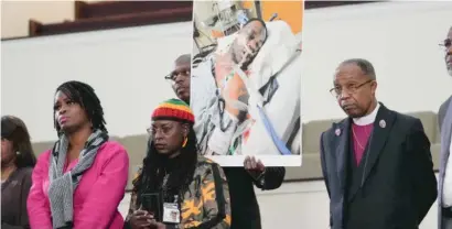  ?? GERALD HERBERT/AP ?? Family members and supporters hold a photograph of Tyre Nichols in the hospital at a news conference on Monday.