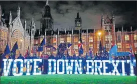  ?? AFP ?? ▪ Writing on the wall: Anti-Brexit demonstrat­ors protest outside Parliament with a giant ‘Vote Down Brexit spelled out in illuminate­d letters.