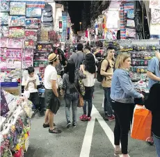  ?? VANESSA PINNIGER ?? Mong Kok is a lively district where you can buy souvenirs, clothing and watches or visit fortune tellers and tea houses.