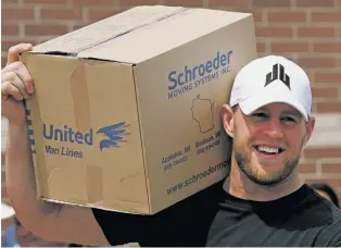  ?? BRETT COOMER/HOUSTON CHRONICLE VIA AP ?? Texans defensive end J.J. Watt holds a box of relief supplies on his shoulder Sunday while handing them out to people impacted by Hurricane Harvey in Houston. Watt’s Hurricane Harvey Relief Fund has raised millions of dollars to help those affected by...