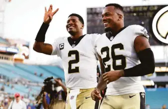  ?? James Gilbert / Getty Images ?? Jameis Winston (2) and P.J. Williams of the Saints celebrate after defeating the Packers. Wilson threw for five touchdowns, and his team intercepte­d reigning NFL MVP Aaron Rodgers twice.