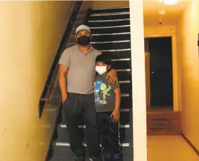  ?? Jennifer Cortez ?? Joel Ramirez and 9yearold son Wilder at their shared apartment on Third Street in BayviewHun­ters Point. Wilder, who attends Bret Harte Elementary while his dad works in constructi­on, only recently got internet access.