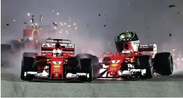  ?? GETTY ?? Crash course: Ferrari team-mates Sebastian Vettel (left) and Kimi Raikkonen collide at the start of the race