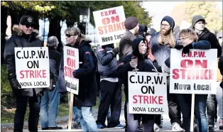  ?? CP PHOTO TED PRITCHARD ?? CUPW members stand on picket line along Almon St., in front of the Canada Post regional sorting headquarte­rs in Halifax on Monday.